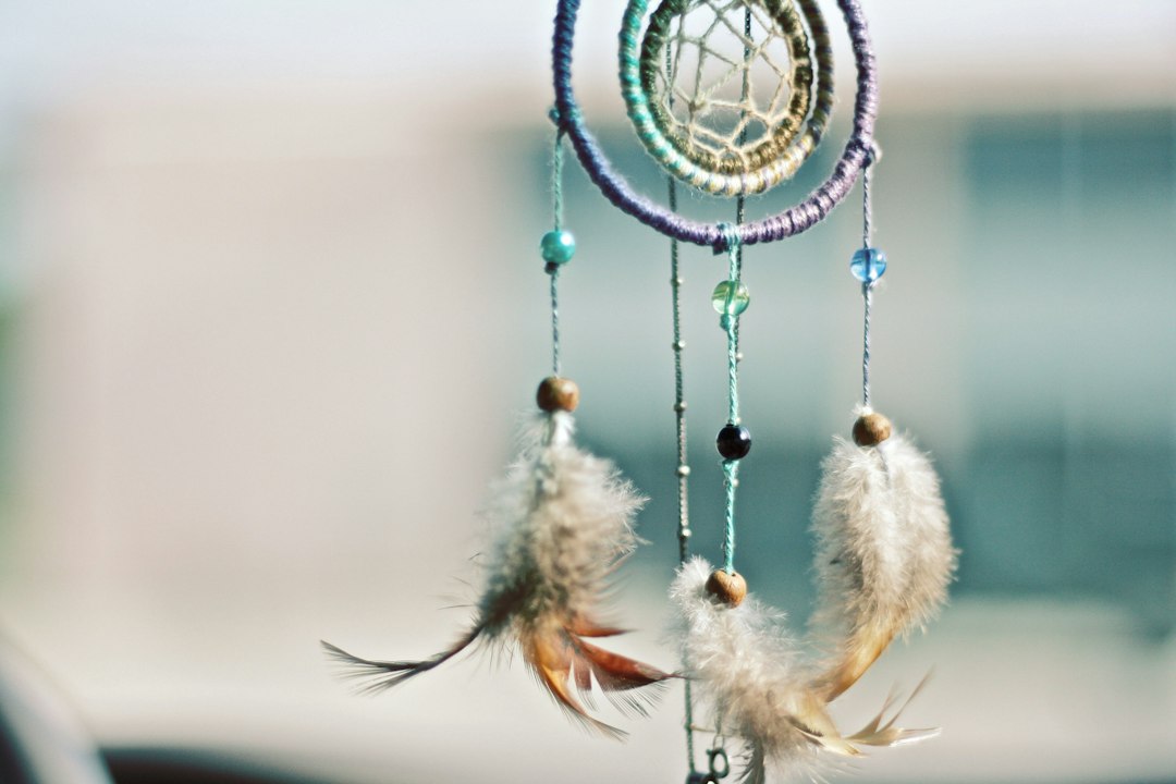 Dreamcatcher with feathers by Dream and Meaning selective focus photography of multicolored dream catcher