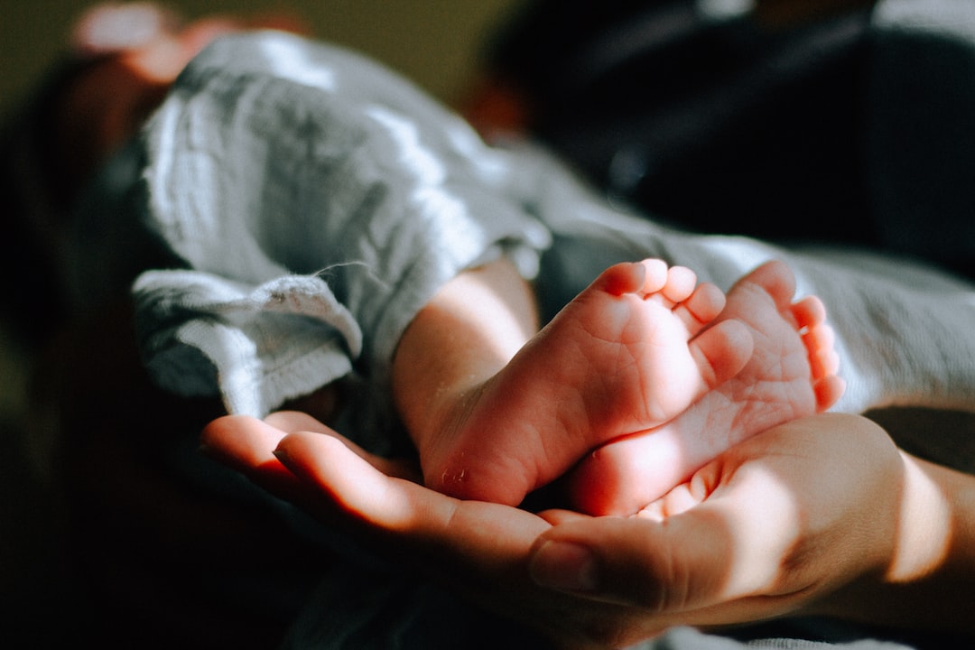 What does it mean when you dream about having a baby but not pregnant? by Dream and Meaning person holding baby feet