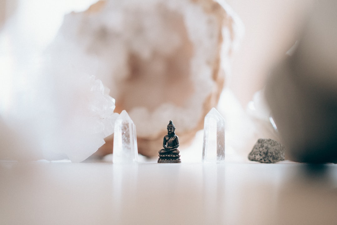 Crystal Consciousness by Dream and Meaning macro photography of black ceramic Gautama Buddha miniature