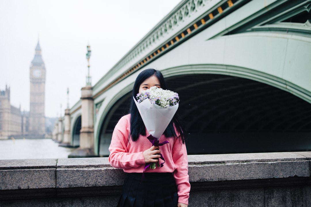 Well with valentines day on a couple of days away, what better way to mark the occasion than to stand in front of Big Ben with a bunch of flowers. I love this City! by Dream and Meaning woman holding flower bouquet standing beside concrete railings