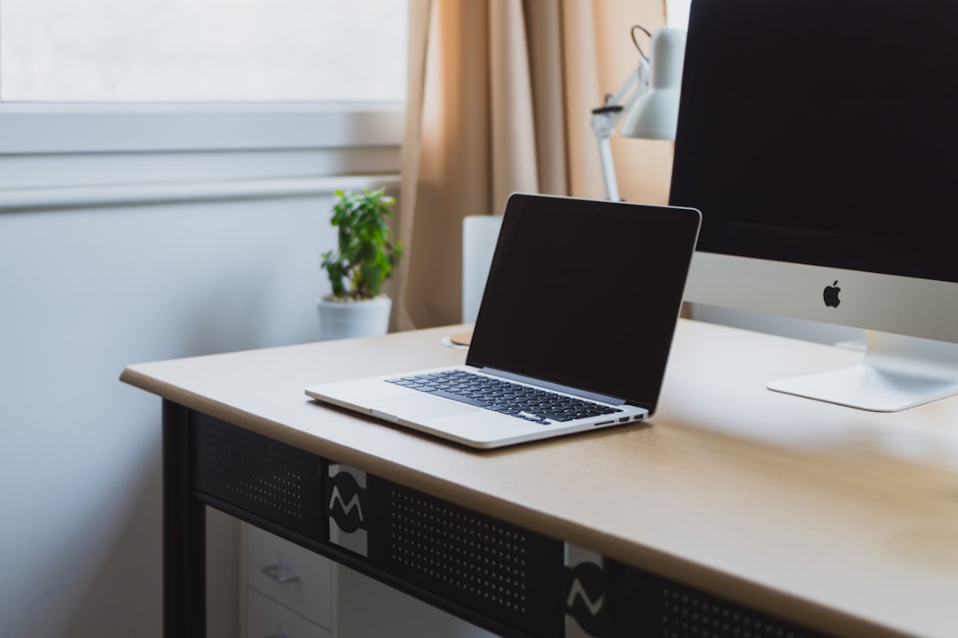 Laptop on a neat desk by Dream and Meaning silver laptop on desk beside silver iMac