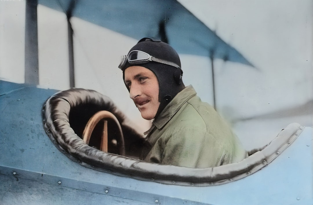 Originally from the Library of Congress, this AI recoloured photograph depicts early aviator Steve MacGordon circa 1915 in the cockpit of a biplane shortly before his death. MacGordon was one of the earliest pioneers in aviation and held many of the inaugural records in flight. by Dream and Meaning man inside biplane
